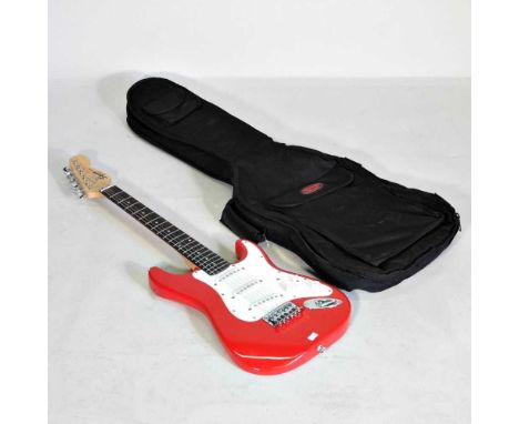 A Squire red mini Fender electric guitar, 89cm long, casedOverall condition appears to be complete and intact, with only the 