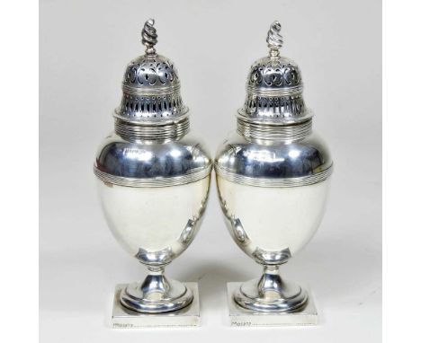 A pair of Edwardian silver table castors, each of baluster shape, with a removable pierced cover, on a square foot, London 19