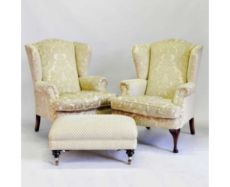 A pair of early 20th century gold upholstered wing armchairs, on cabriole legs, together with a modern upholstered footstool,