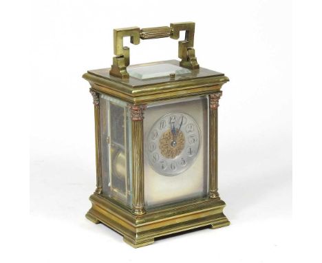 A 19th century French brass cased carriage clock, the case flanked by columns, with push repeat, 20cm high overall, in a fitt