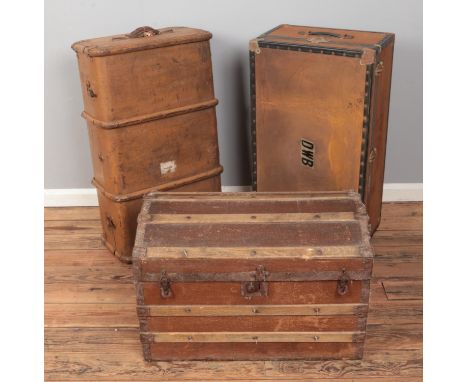 Vintage steamer trunk along with dome top example and other travel trunk.  