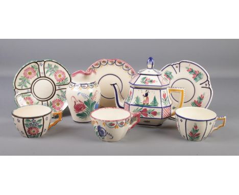 A collection of Quimper ceramics. Includes teapot, jug and three large cups and saucers.  