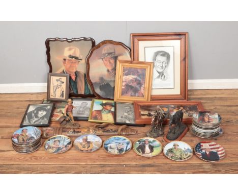 A large collection of John Wayne memorabilia to including assorted pictures, cabinet plates, rifle display and figures.  