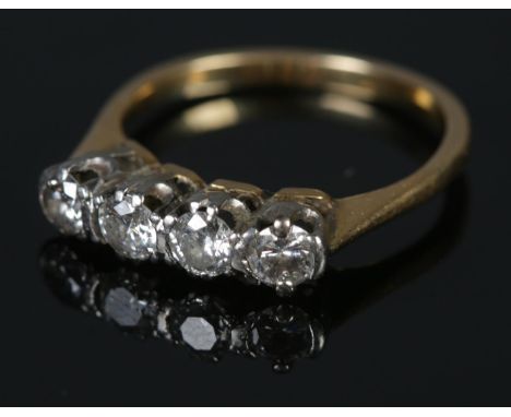 A 14ct gold four stone diamond ring. Approximately 0.6ct diamond. Size K. 2.46g gross weight.  Tests as 14ct gold.