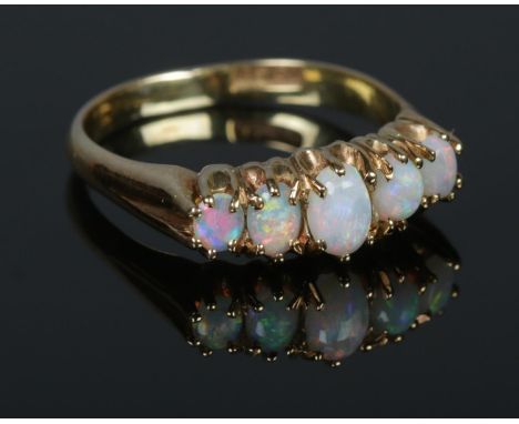 A Victorian Gold and five stone Opal ring, stamped 15ct to the inside of the band. Size Q. Total weight: 4.2g  