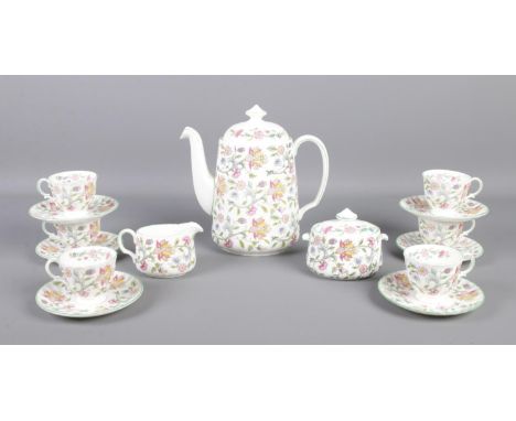 A Minton Haddon Hall six place tea service. To include cups and saucers, tea pot, sugar bowl and cream jug.  