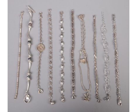 Eleven silver bracelets, to include examples with paste set, weighing scales and heart shaped padlock. Total weight: 77g.  