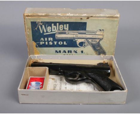 The Webley "Mark I" 0.22cal air pistol, with chequered grip and in original box, with leaflet. Stamped 890. With a box of "Ma