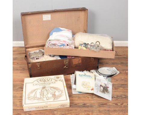 A trunk containing a large quantity of lace and linen along with boxed Dryad lace making kit, cross stitch kits and embroider