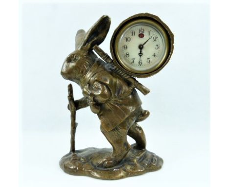 German mantel clock in brass drum case carried upon the back of a wayfaring hare.  18cm. Condition Report. Working clock, goi