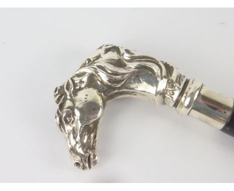 Walking stick, the handle with silvered superimposed horses' heads on copper.