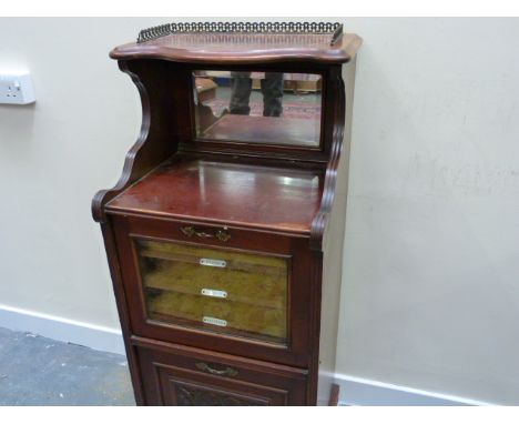 Early 20th century mahogany music cabinet with gallery and shelf top with mirror back, glazed door enclosing named shelves ab