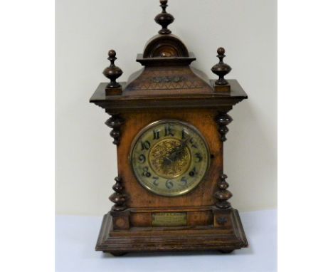 Victorian mantle clock with gilt dial in walnut case inscribed and dated 1899.  47cm. 