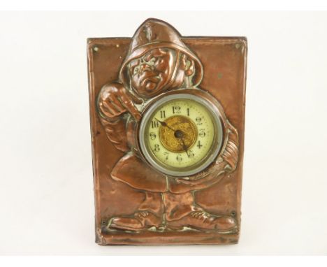 Amusing Edwardian oak desk clock with copper mask embossed with caricature policeman indicating the time.  16.5cm.