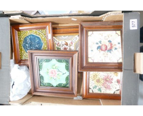 A collection of framed tiles including a triple tile panel and four single vintage tiles, all in wood frames (5)