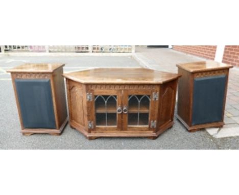 20th Century oak 2 door leaded glazed TV unit with canted sides, along with a pair of matching speaker cabinets (3)