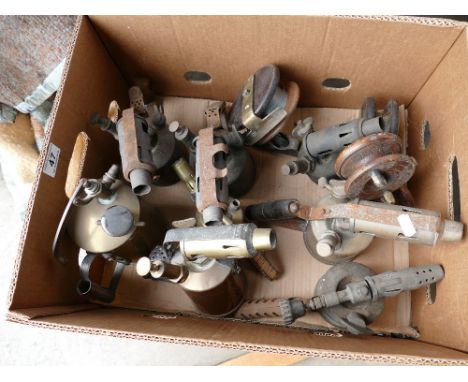 A collection of Primus branded vintage blow lamps with vintage fishing reels 
