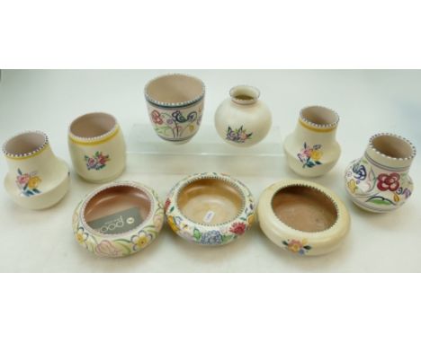 A collection of Poole Pottery floral decorated vases, small planters and squat bowls in varying designs (height of tallest 12