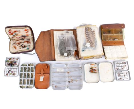 A collection of vintage fly fishing flies in Wheatley tins and wallets. The green wallet a few pasted down colour prints of f