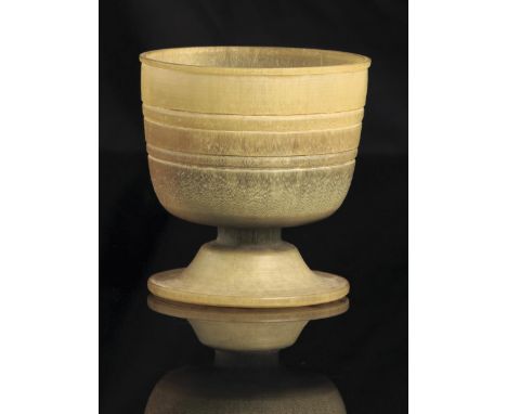 &lambda; A Sudanese turned rhinoceros horn stem cup, with two bands to the main body, early 20th century, 8.5cm high, 147 gra