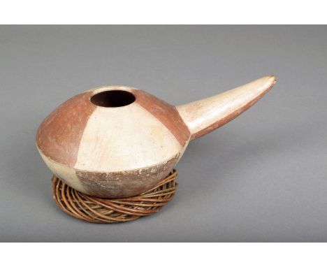 A Nazca ladle, of compressed circular form with a tapering handle, with two-tone panel decoration, 29cm long, with a later wo