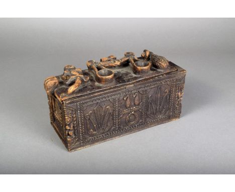 A Nias carved jewellery box, Indonesia, with panels of every day objects and foliage, with ancestors to the corners, the lid 