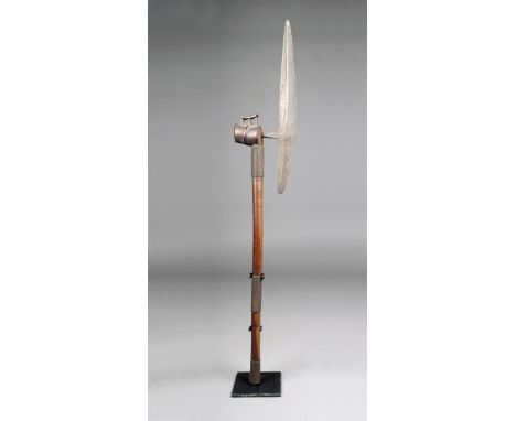 A Tsonga ceremonial axe, South Africa, with a wood handle having three wire bands and a single ribbed head with a headrest su