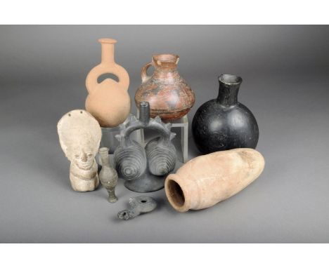Two Pre-Columbian pottery stirrup vessels, 18cm the highest, a blackware ovoid vessel, a pottery figure, a decorated vessel w