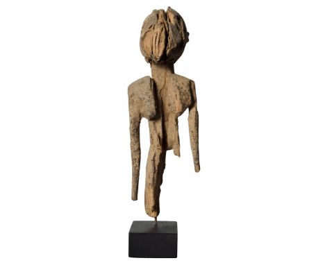 A Lobi fragmentary standing figure, Burkina Faso, 32cm high. Provenance: Ian Auld. Published: Michael Pennie. Adventures with