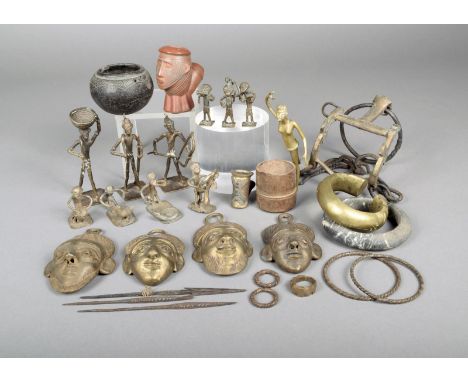 Ten Ashanti brass figural gold weights, 13cm the tallest, four Nigerian brass hip masks, a brass pounding figure with mortar,