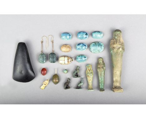 An Egyptian faience Ushabti, 11.3cm high, another Egyptian Ushabti, 6.1cm high, a Ushabti amulet with hieroglyphs, 4.8cm high