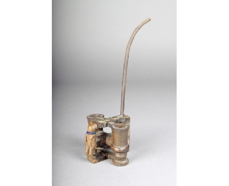 A Lwena or Chokwe double pipe, Angola, of cross form, the front carved a standing figure with ribbed coiffure and with beads,