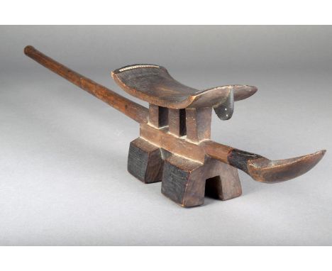A Tsonga headrest ladle, Mozambique, the long status handle with a pierced end to a block footed base and triple support to a