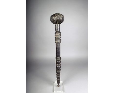 An unusual ebonised wood club, with a reel turned shaft, the top ring pierced and a lemon squeezer type head, 77.5cm long. Pr