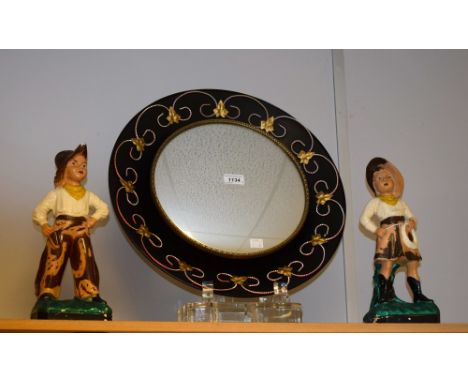 A 1960s kitsch light-up circular wall mirror; a pair of 1960s moulded plaster figures, cowboy and cowgirl, dated 1964