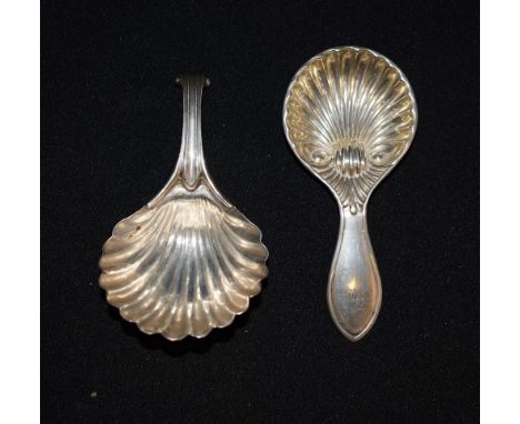 An early 19th century silver caddy spoon, as a scallop shell,  Birmingham 1835; another similar caddy spoon (2)