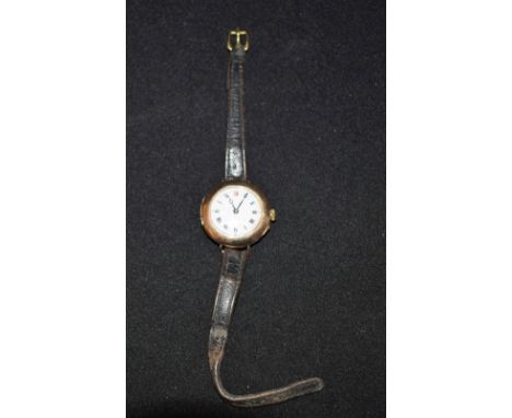 A lady's 9ct gold wristwatch, black leather strap, Roman numerals, white enamel dial