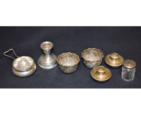 A pair of Victorian silver salts, embossed with foliate scrolls, London 1886; a silver tea strainer on stand, Birmingham 1939