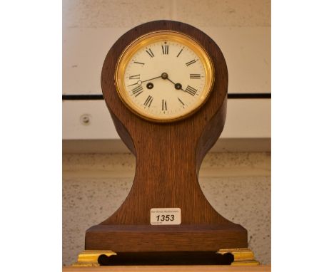 An Edwardian balloon mantel clock, white enamel dial, Roman numerals, brass feet