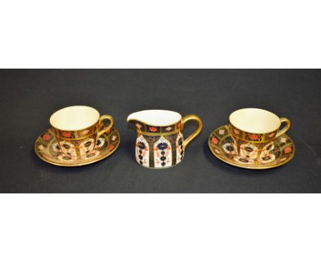 A pair of Royal Crown Derby 1128 Imari pattern cups and saucers, solid gold band; another, cream jug (5)