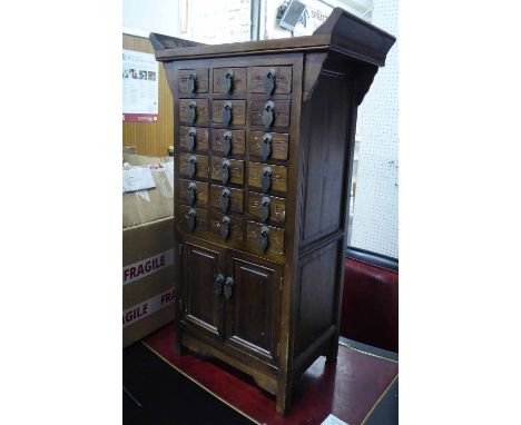 SMALL CHINESE CHEST, in solid wood with eighteen small drawers and cupboard below, 48cm x 27cm x 79cm H. 