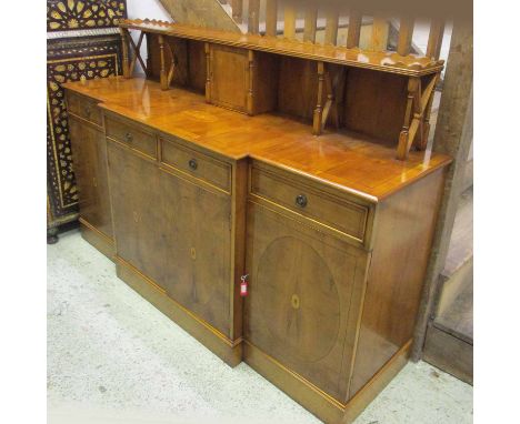 BREAKFRONT SIDEBOARD, yewwood with a raised galleried shelf back with door above four drawers and panelled doors on a plinth 