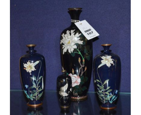 Four Japanese cloisonne vases, decorated with birds and foliate panels, on blue ground, 10, 16 and 25cm high (3) CONDITION RE
