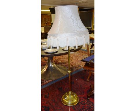 A late Victorian brass floor lamp and shade, with turned stem, ending in circular base (converted), 154cm high