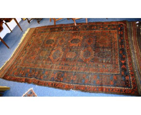 A Timuri carpet, with two rows of six panels, over brown ground in blue and red with triple borders, 303 x 197cm