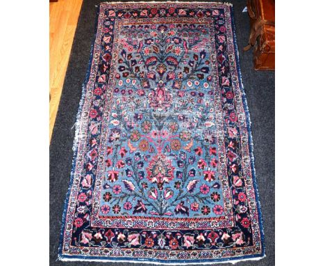 An antique Persian Dorokhsh rug, the floral design over light blue ground and triple border, 152 x 88cm