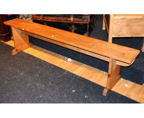 A vintage pine kitchen bench, raised on splat supports, 46cm high