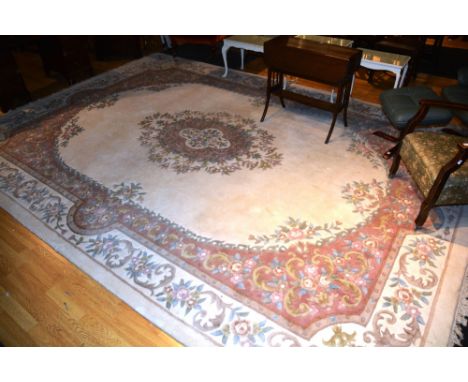 A large Chinese carpet, the central rosette over cream ground and pink floral border, 420 x 305cm