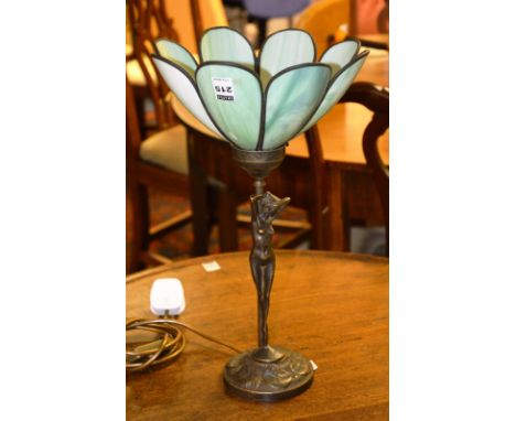 An Art Nouveau style patinated spelter figural table lamp, in the form of a nude female, raised on circular base with green s