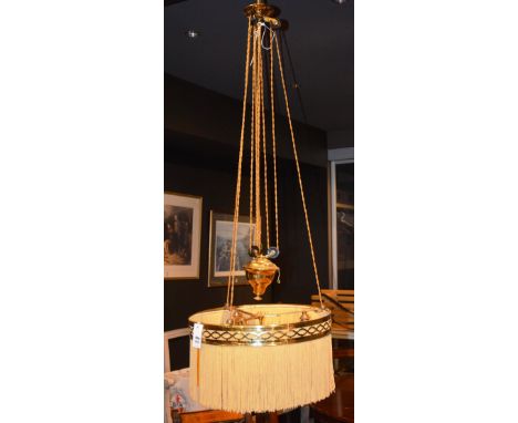 A Victorian brass rise and fall ceiling light, the pierced brass circular frame with suspended fabric tassels, brass coated w